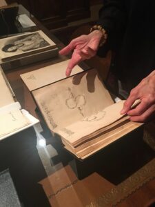 Two hands holding a book of dance notation