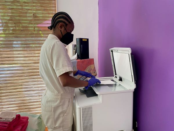 A woman standing at a copy machine