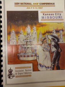 A booklet with text and illustrations of dancers and a cityscape on the cover