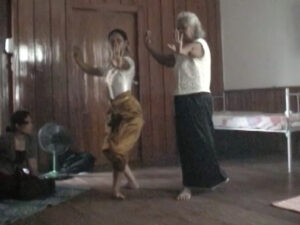 Two dancers, one in front of the other, holding a pose.