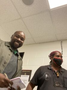 A smiling person next to a person wearing a mask.