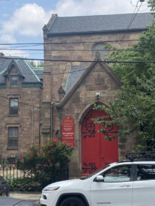 A large stone building with red double doors