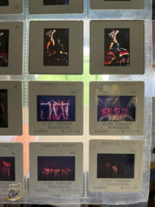 A sleeve containing many small slides of color dance photographs