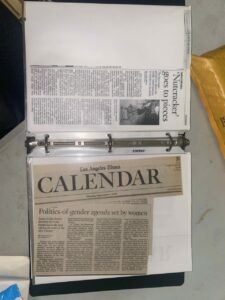 A binder with press clippings inside