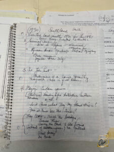 A spiral notebook with handwritten text