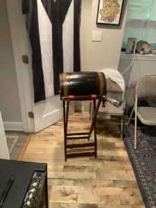 A wooden stand with a cylindrical drum on top