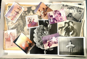 Lots of old photographs, color and black and white, lying in an overlapping pile.