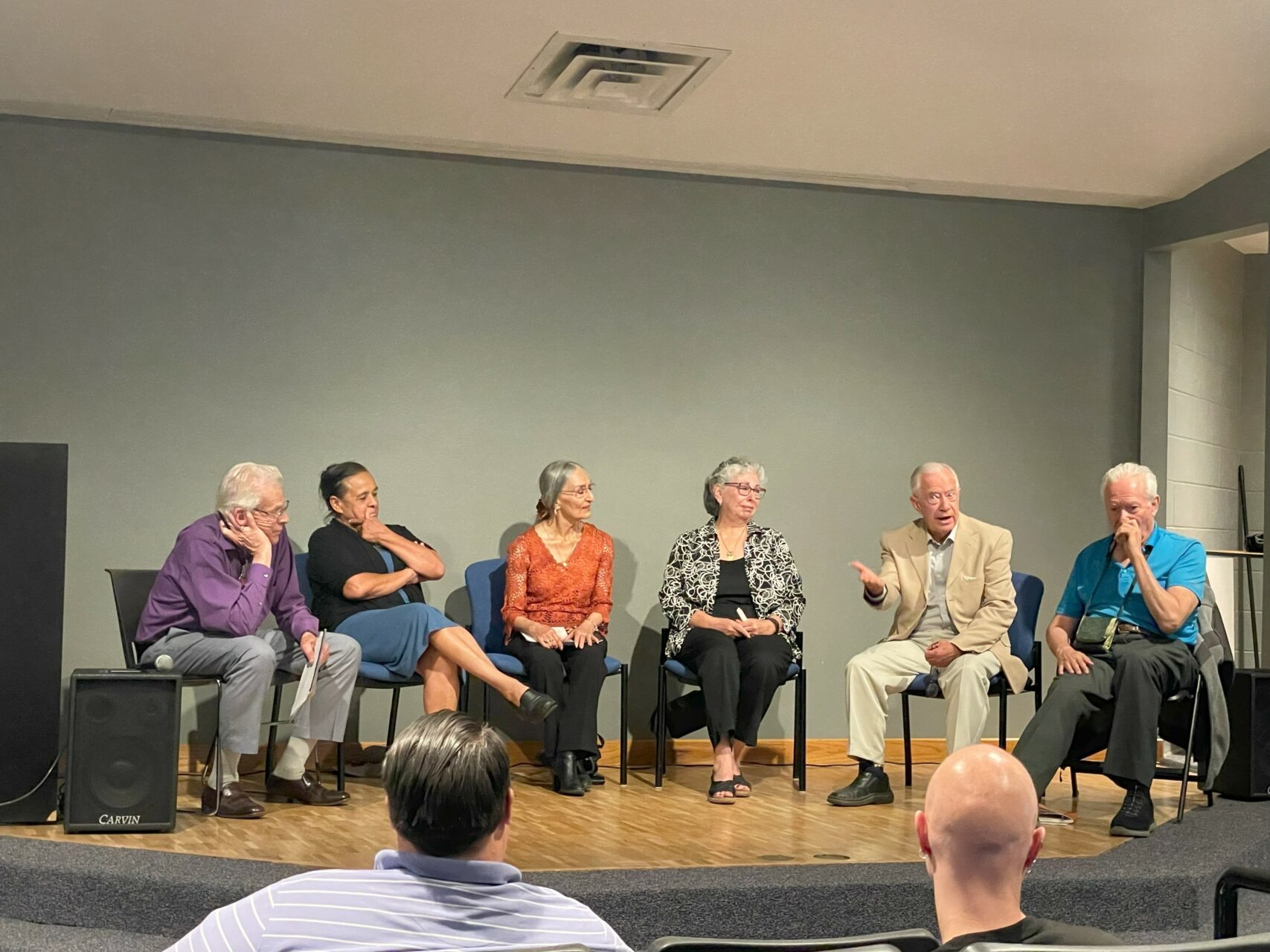 A panel discussion featuring six people sitting on stage.