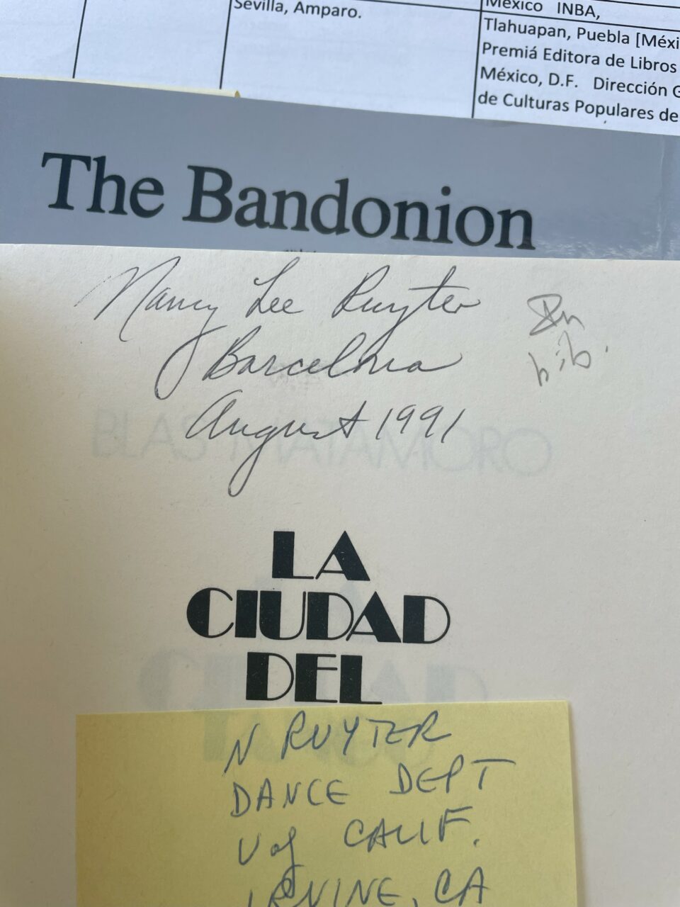 The title page of a book reading "La Ciudad Del" with handwritten information reading "Mary Lee Ruyter, Barcelona, August 1991" and a sticky note reading "N Ruyter, Dance Dept, U of Calif., Irvine, CA